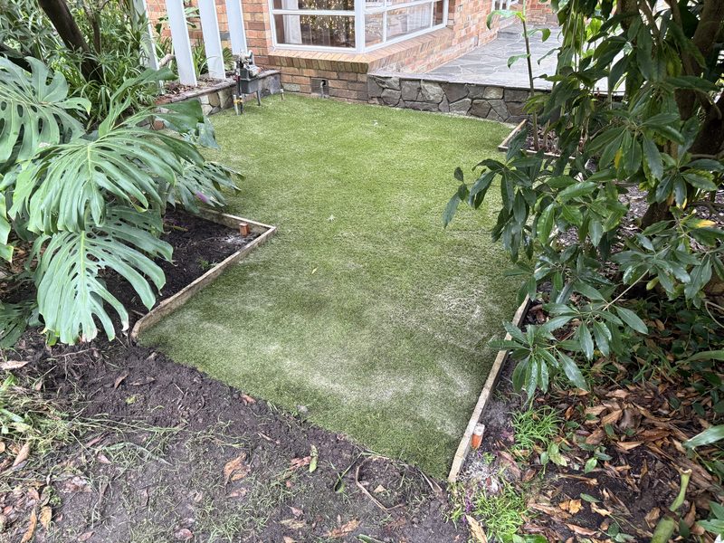 A neat garden-nook lawn framed by greenery